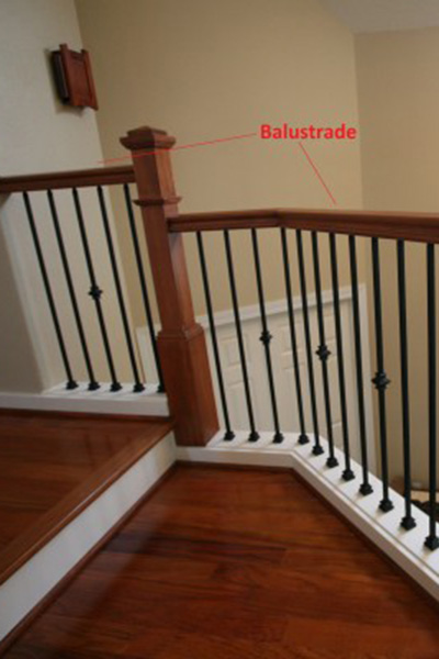 Staircase image of balusters with red text pointing to wood balusters