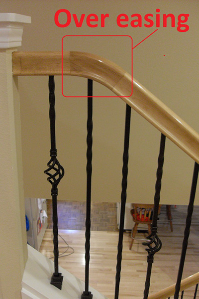 Staircase railing showcasing the portion where railing begins descending