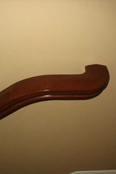 Top of staircase railing that appears to go into wall