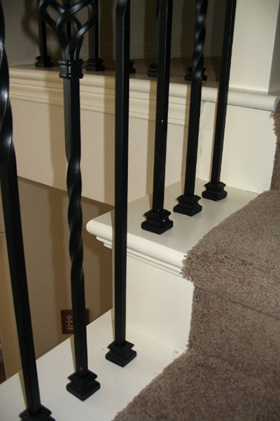 False-tread-cap- Close up image of the bottom of staircase railing showcasing a false tread cap