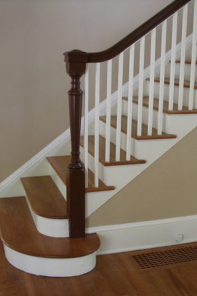 Bottom of staircase showcasing a newel post