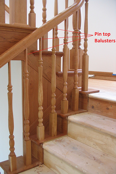 Image of staircase railing pointing to pin top balusters