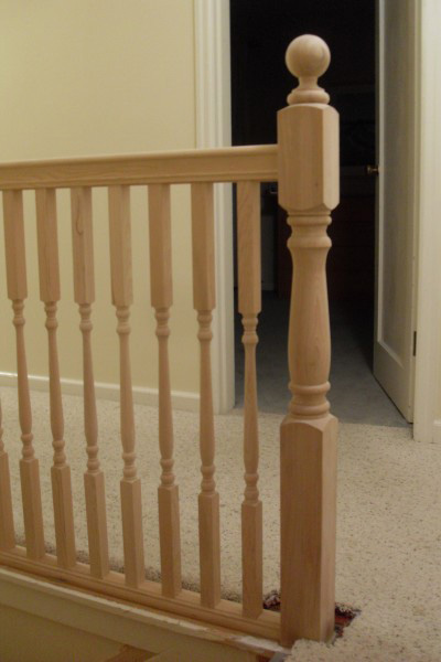 Image of staircase railing highlighting the square top baluster at corner of railing